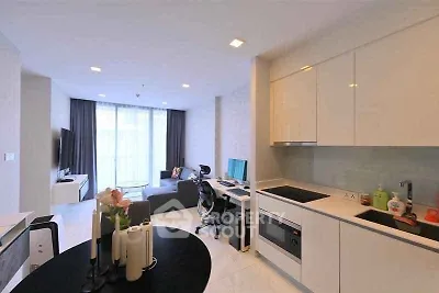 Modern open-plan living room and kitchen with sleek design and natural light.