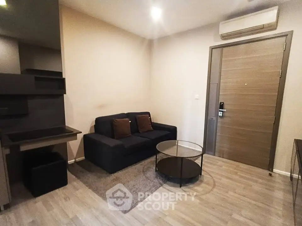Modern living room with sleek furniture and air conditioning in a cozy apartment.