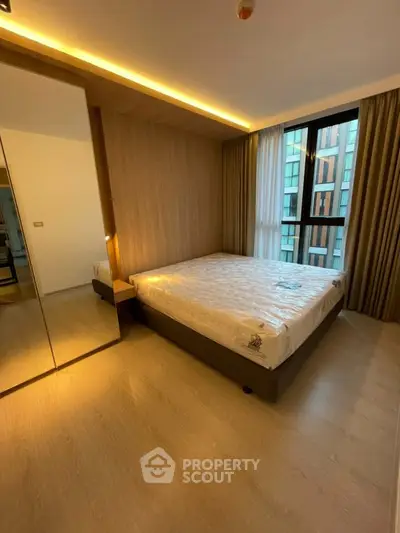 Modern bedroom with large window and wooden accents in luxury apartment