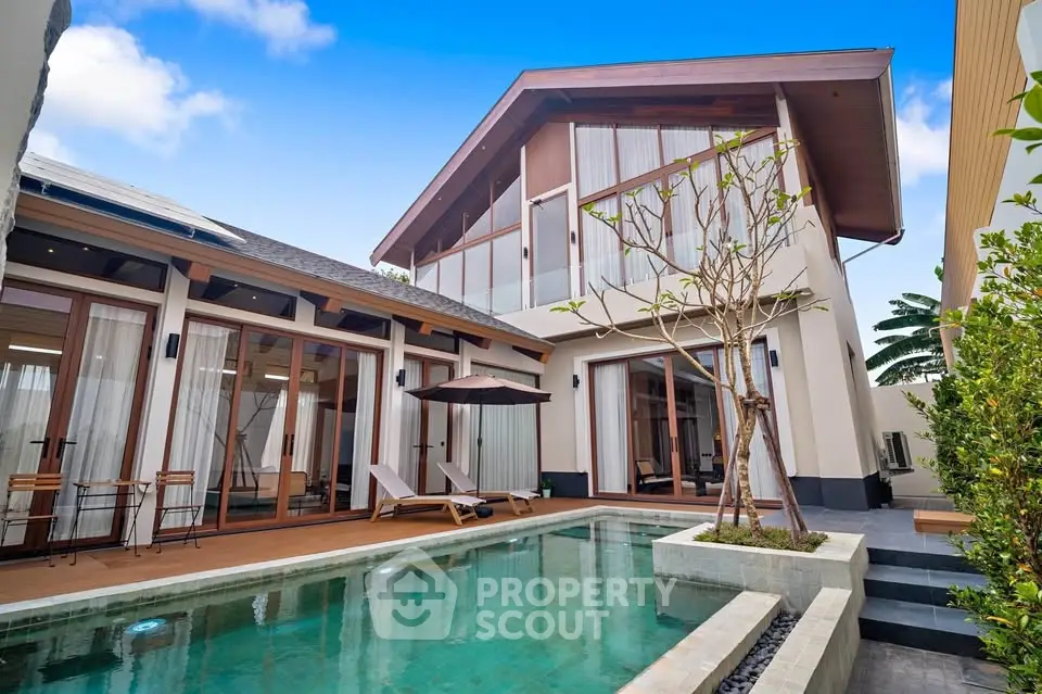 Luxurious modern villa with private pool and spacious deck area, perfect for relaxation and entertainment.