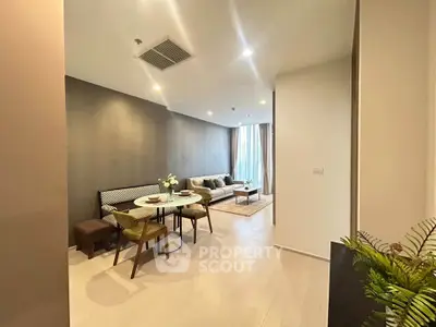 Modern living room with dining area, stylish decor, and natural light.