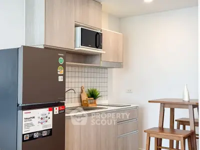 Modern kitchen with sleek appliances and stylish wooden cabinetry