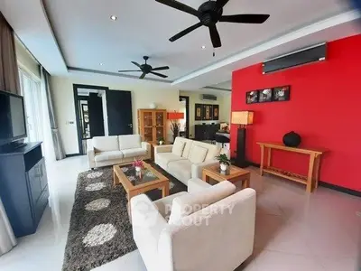 Spacious modern living room with stylish decor and ceiling fans