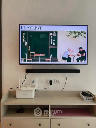 Modern living room with wall-mounted TV and sleek storage unit