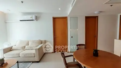 Modern living room with cozy sofa and dining area in a stylish apartment.