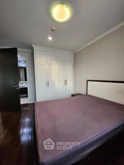 Spacious bedroom with large wardrobe and elegant lighting
