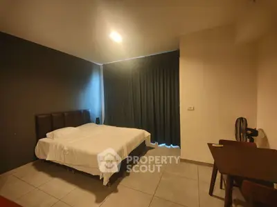 Cozy bedroom with modern decor and natural light, perfect for relaxation and comfort.