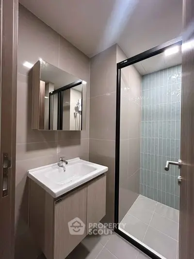 Modern bathroom with sleek design featuring a glass shower enclosure and stylish vanity.
