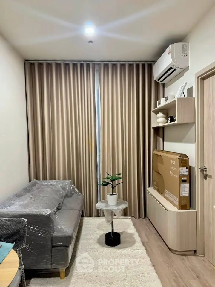 Modern living room with sleek furniture and air conditioning, perfect for cozy urban living.