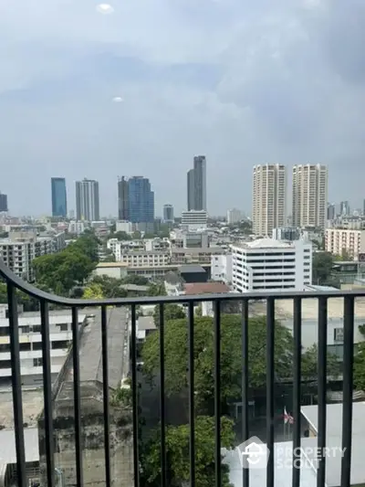 Expansive cityscape view from a high-rise balcony, showcasing a bustling urban environment with a mix of modern skyscrapers and traditional buildings.