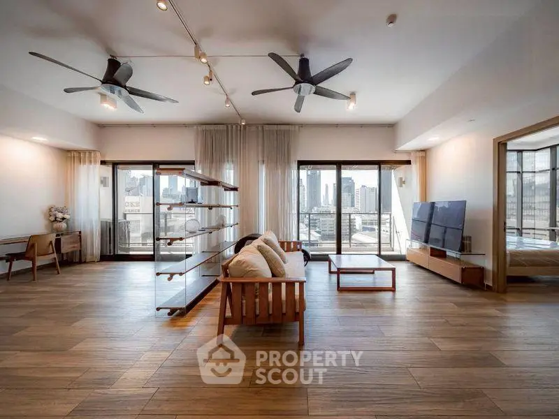 Spacious modern living room with city view and stylish wooden flooring