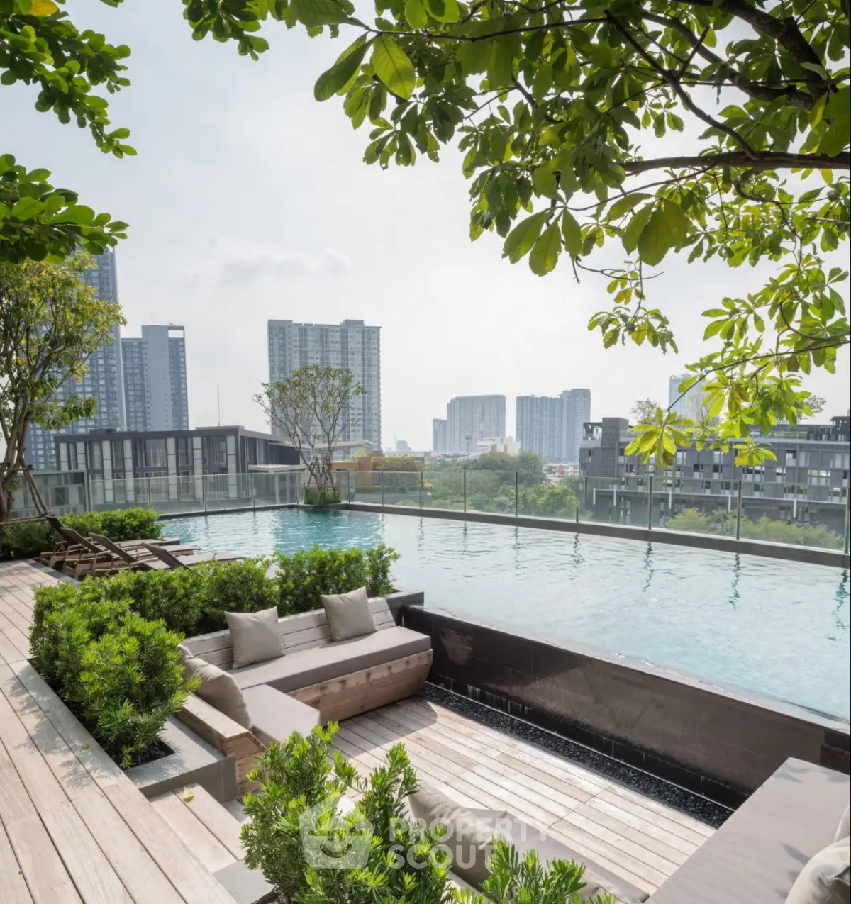 Luxurious rooftop pool with city skyline view and lush greenery
