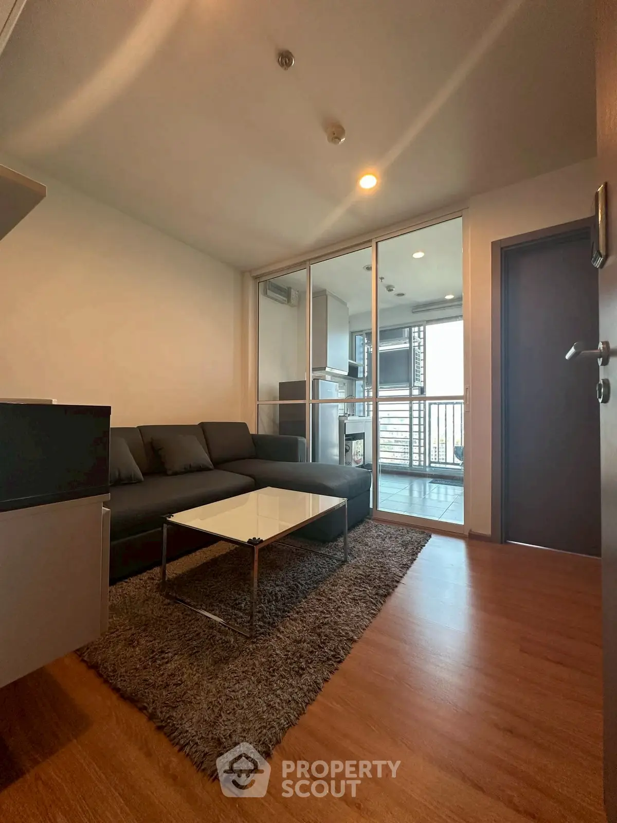 Modern living room with sleek furniture and balcony view in urban apartment