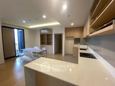Spacious modern kitchen with open layout and dining area in a stylish apartment.