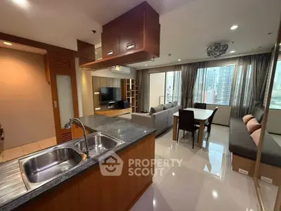 Spacious modern living room with open kitchen and city view, perfect for urban living.
