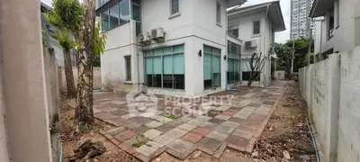 Spacious modern house with paved backyard and air conditioning units, ideal for family living.