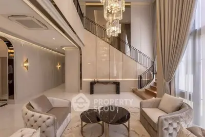 Luxurious living room with high ceilings, elegant chandelier, and modern furniture in a spacious interior.