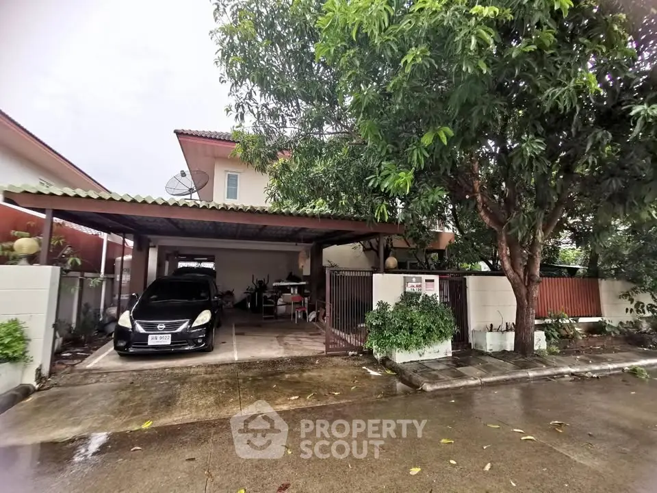 Charming suburban home with carport and lush greenery, perfect for family living.