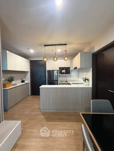 Modern kitchen with sleek cabinetry and open layout in a stylish apartment.