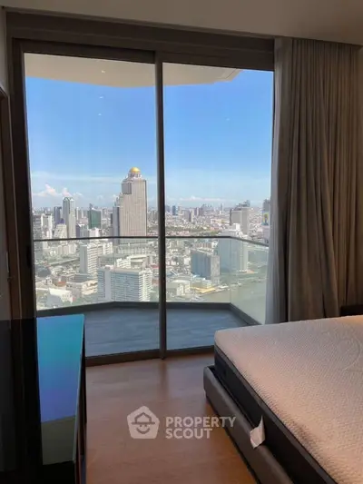 Stunning city view from modern bedroom with floor-to-ceiling windows and balcony access.