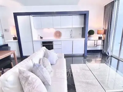 Modern open-plan living room with sleek kitchen and stylish decor