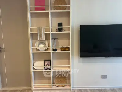 Modern living room with stylish shelving and wall-mounted TV, perfect for contemporary urban living.