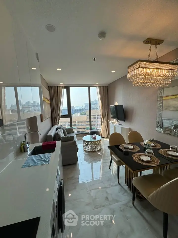 Luxurious modern living room with city view, elegant chandelier, and stylish dining area.