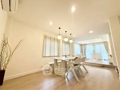 Spacious modern living room with elegant dining area and stylish lighting