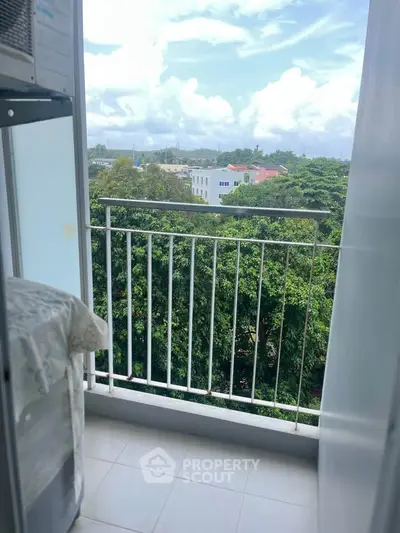 Charming balcony with lush green view, perfect for relaxation and enjoying nature.