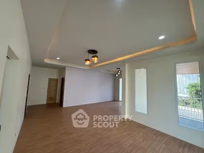 Spacious modern living room with elegant lighting and large windows