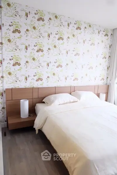 Charming bedroom with floral wallpaper and modern wooden furniture, perfect for a cozy retreat.