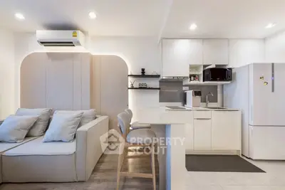 Modern open-layout kitchen and living room with sleek design and neutral tones