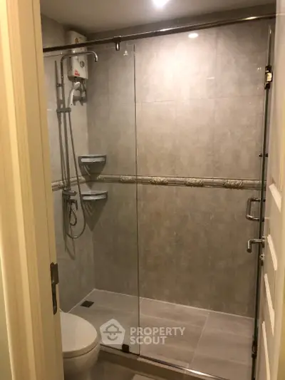 Modern bathroom with glass shower enclosure and sleek fixtures