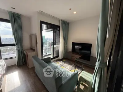 Modern living room with balcony and city view, featuring stylish furniture and natural light.