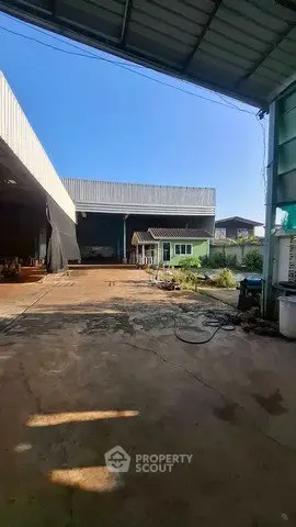 Spacious industrial property with large open area and covered warehouse space.