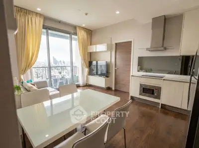Modern open-layout kitchen and living area with city view and elegant furnishings.