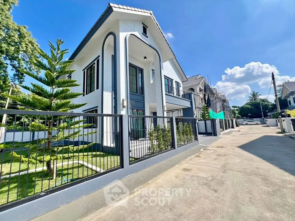 Stunning modern two-story house with sleek design and lush garden in a serene neighborhood.