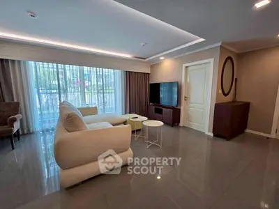 Spacious modern living room with elegant furniture and large windows for natural light.