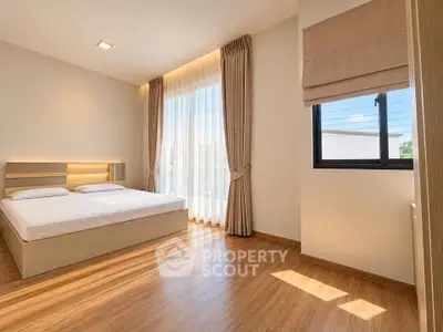 Spacious bedroom with natural light and modern design in a luxury home.