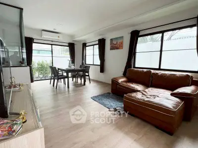 Spacious living room with modern decor and large windows