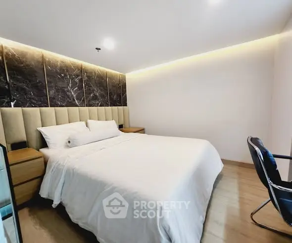 Luxurious modern bedroom with elegant lighting and plush bedding