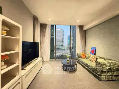 Modern living room with city view, stylish decor, and large windows in urban apartment.
