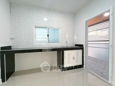 Modern kitchen with sleek black countertops and white subway tile backsplash