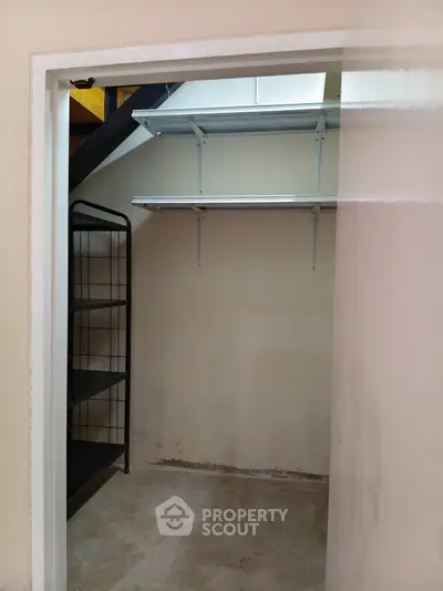 Spacious storage room with metal shelving and open floor space.