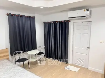Cozy bedroom with modern air conditioning and stylish curtains