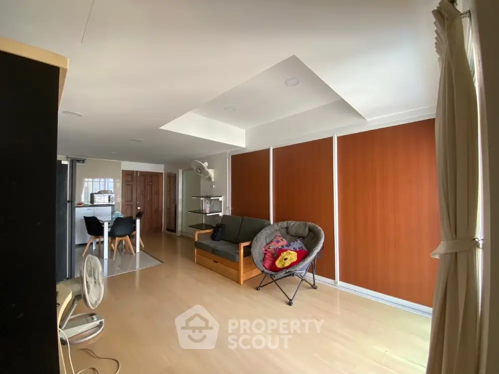 Spacious living room with modern decor and wooden accents