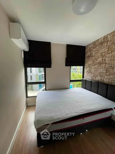 Modern bedroom with large windows and stylish decor in urban apartment