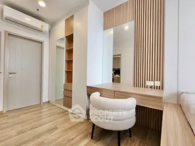 Modern bedroom with stylish wooden accents and cozy seating area.
