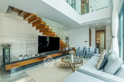 Luxurious modern living room with elegant staircase and stylish decor