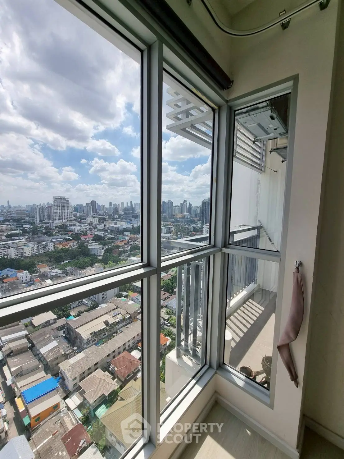 Stunning high-rise apartment view with expansive cityscape and balcony access.